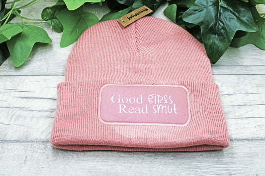Flat lay of Good Girls Read Smut vinyl beanie